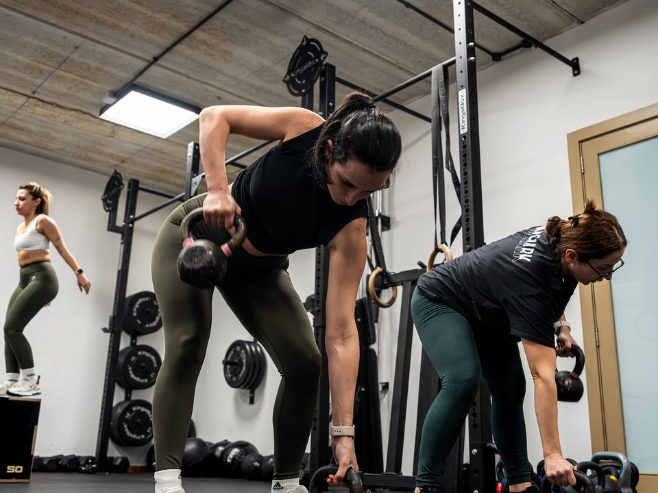 Members doing kettlebell rows in a SCULPT class